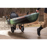 Man pulling kayak from a boat launch using a YakAttack TowNStow Bunkster Kayak Cart