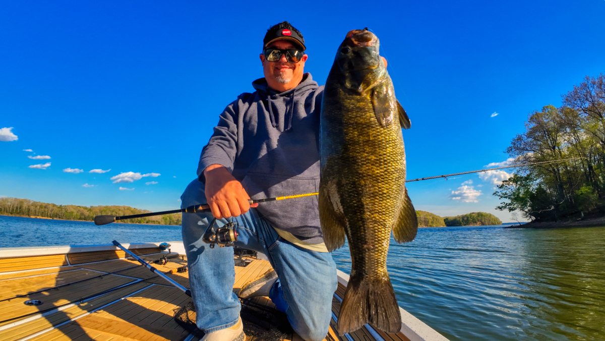 Angler holding a large smallmouth bass caught on a Trout Magnet micro finesse presentation