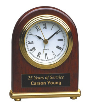 Clock rosewood piano finish arch 4 inches wide by 5 inches high.