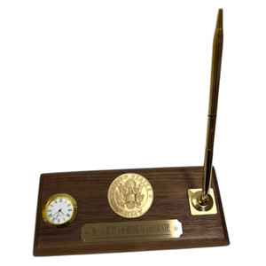 Genuine walnut desk set with miniature clock and one quality brass pen. 3-1/2 inches wide by 8 inches long. Emblem can be Army, Air Force, Navy, Marines, Coast Guard or Space Force, please specify. Laser engraved images are also available.  A fresh battery is installed prior to shipment. Battery number 377.