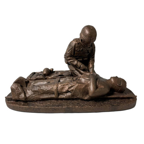 A military statue of a male Soldier medic, 8.5 inches tall, 12 inches long, and 8 inches wide, with a slot for a challenge coin in the front, and no wooden base.