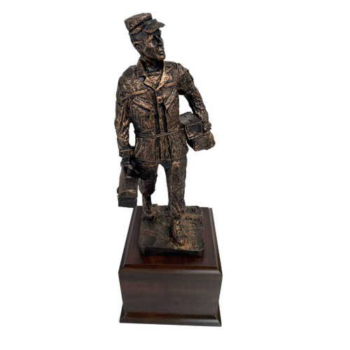 This is a 15-inch-tall statue of a male Army or Air Force mechanic, mounted on a laminated cherry wood base measuring 5-1/2 inches square and 4 inches high. The statue itself stands 11 inches tall.