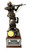 A 14-1/2 inch tall military statue depicts a U.S. Soldier aiming a rifle while shielding a wounded comrade, set upon a laminated cherry base.