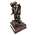 Military statue of a female Soldier with Warrior Ethos. Impressive statue depicting a female service member assisting a wounded warrior, mounted on a 6.5 long x 6.5 wide x 1-3/4 inches high laminated cherry base. The total assembled product height is 12 inches, the Warrior Ethos is displayed on front.
