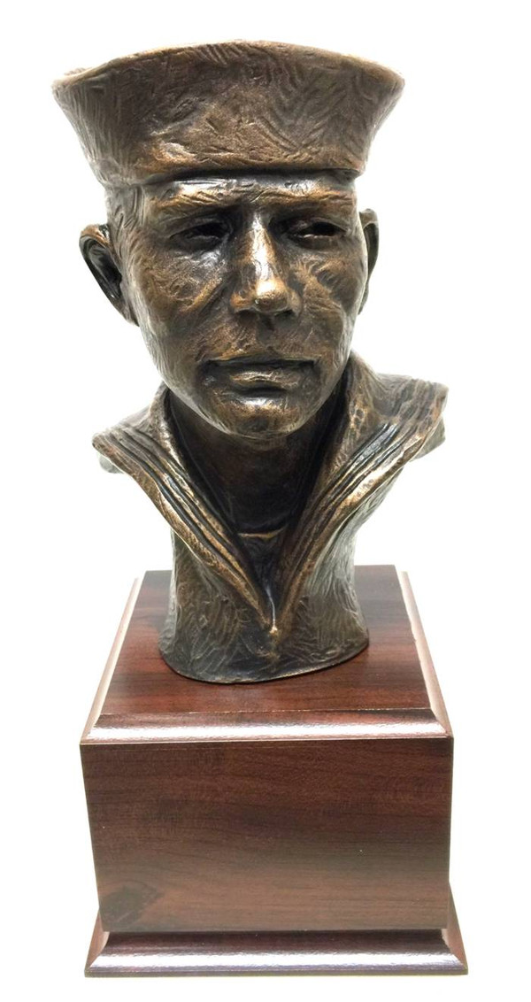The statue is a 12-inch-high bust of a Sailor, mounted on a laminated cherry base that is 5.5 inches wide, long, and 4 inches tall. Free engraving is included with the statue.