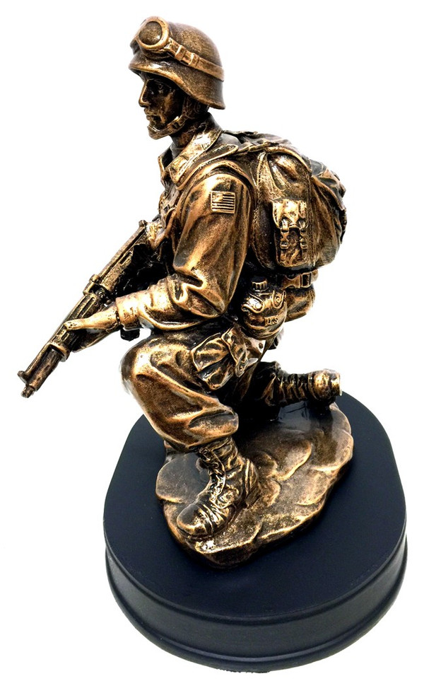 10" tall bronzetone Soldier kneeling holding rifle military statue mounted on black base.