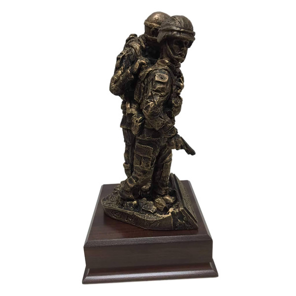 Soldier Female with Warrior Ethos Military Statue, Awesome military statue of a female service member assisting a wounded warrior mounted on a 6.5"W x 6.5"D x 1-3/4"H laminated cherry base.  Total height is 12". Warrior ethos is shown on the front.