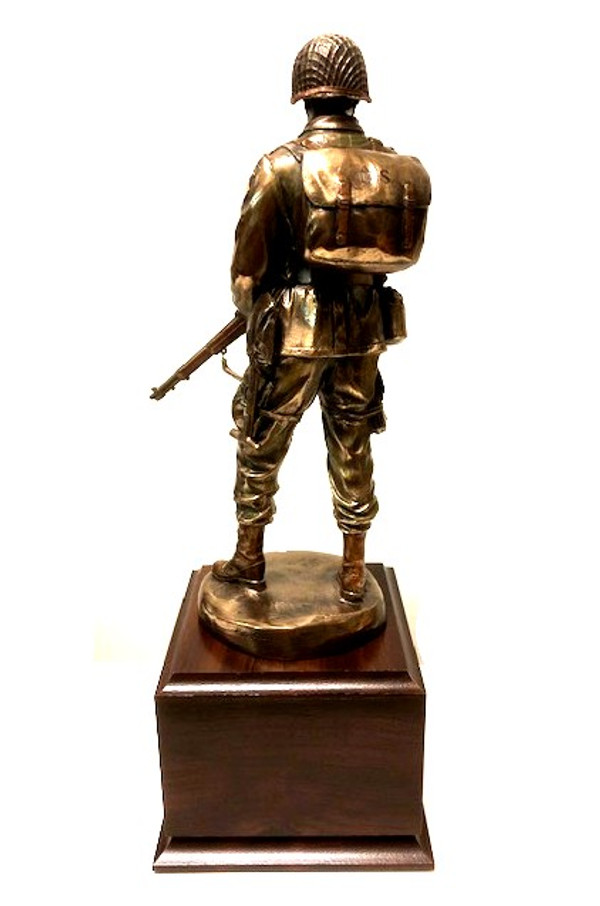 Honor and Courage is a WW II military statue that stands on a cherry laminated base. The base measures 5-1/2 inches in width, 5-1/2 inches in depth, and 4 inches in height. The statue itself is 11 inches tall, making the total height 15.5 inches.