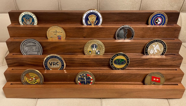 5 tiers genuine walnut challenge coin display stand.  Holds 7 each 2 inches coins per tier.  16 inches wide by 5 inches deep by 6-1/2 inches high.  Challenge coins are not included.