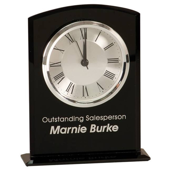 Desk clock in black and silver acrylic, mounted on a base, stands 6-1/4 inches tall, comes with a battery and offers complimentary engraving.