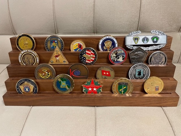 4 tiers genuine walnut challenge coin display stand.  Holds 7 each 2 inches coins per tier.  16 inches wide by 4 inches deep by 5 inches high. Challenge coins are not included.