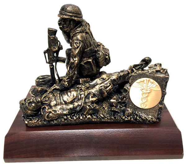 9" tall, 10" long, 7" wide male Combat Medic military statue mounted on a 8" x 11" x 1-1/2" laminated cherry base.  "Calling Dustoff"  Also available on female version. Unit logo coin can be mounted on the small plate holder on the statue.