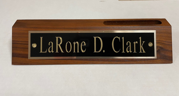 Desk Nameplate Genuine Walnut 2 inches tall by 10 inches wide. Engraving Plate is 1-3/4 inches tall by 8 inches wide.