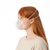 Woman wearing respiratory mask side on to show the 2 silicon straps around her head.