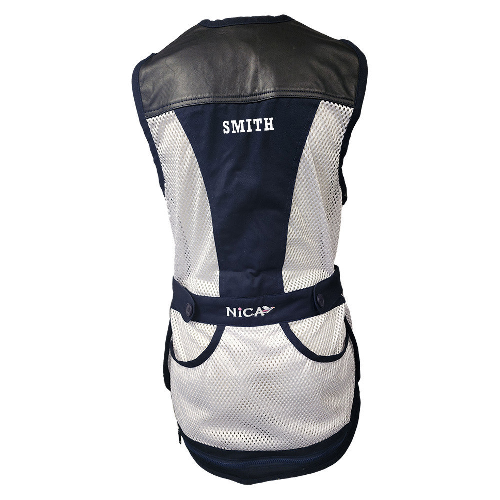 Back view of a navy and white mesh shooting vest with leather shoulders; "SMITH" and "NICA" text.