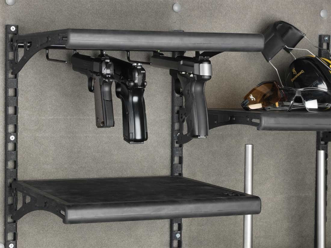 Black gun rack holding two handguns inside a Browning gun safe.