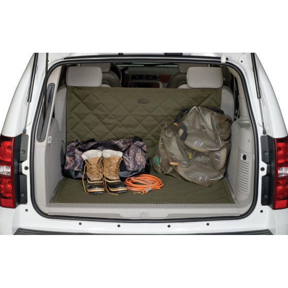 Green quilted cargo protector in a white SUV cargo area, with boots, bag, and mesh bag.