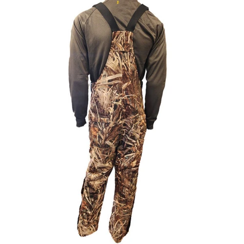 Wildfowler Wildgrass camo waterproof hunting bibs seen from behind on a person wearing a grey shirt.