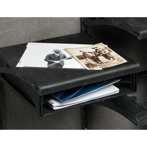 Black file box with photos and notebooks on shelves inside a gun safe.