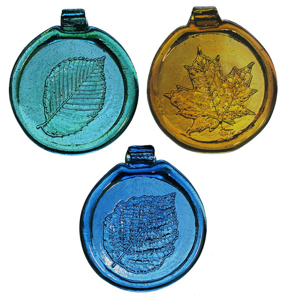 a trio of round glass suncatchers with relief images of leaves on each: a green elm leaf, a yellow maple leaf, and a blue birch leaf