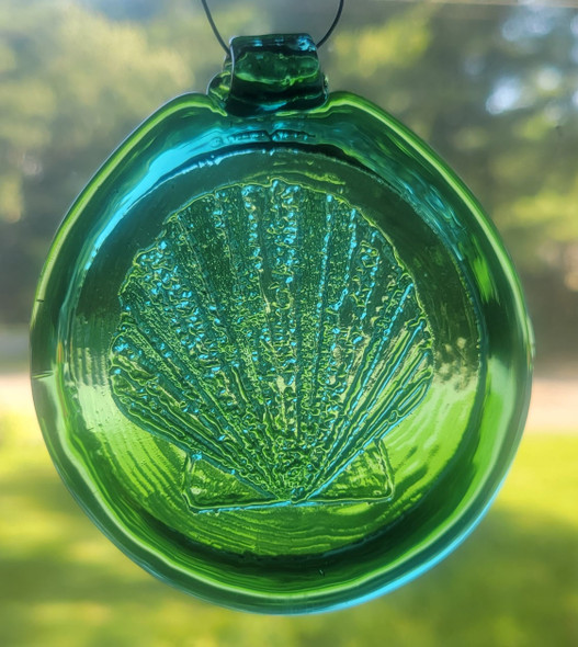 Teal green suncatcher with a scallop shell design.