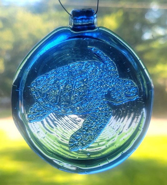 Blue suncatcher with a sea turtle design.