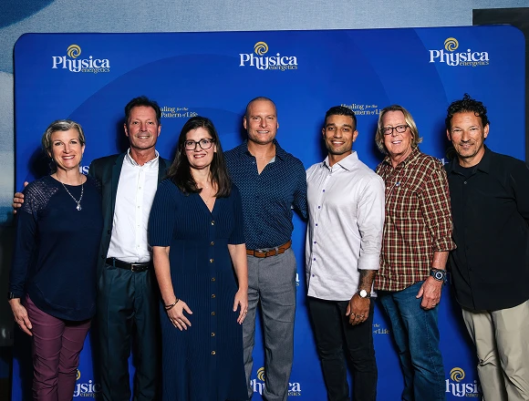 Seven Homecoming speakers and hosts in front of the Physica backdrop