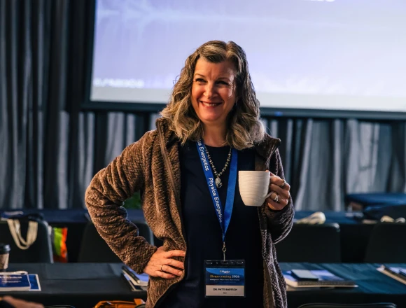 A woman smiling at the welcome reception
