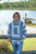 another angle of a Young lady wearing the Baja Joe Mexican hoodie pastel pistachio