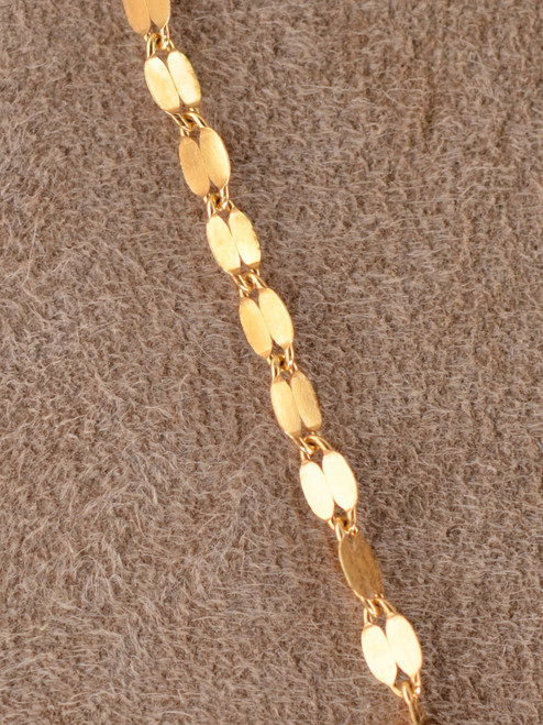 The Paloma Necklace is crafted from luminous 14k gold-filled flat oval links each link reflecting light like tiny mirrors for a fluid, glowing effect.