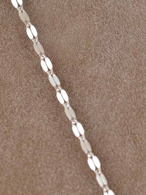 Drape yourself in molten silver radiance.  The Valencia Double Lariat is a striking two-tier chain necklace crafted from sterling silver links, designed to float and shimmer on the neckline and decolletage.