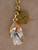 Close-up of the San Benito Lariat showcasing Saint Benedict medallions, Swarovski Trilliant crystal, 28mm Swarovski pear drop, and 14k gold overlay chain