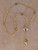 San Benito Lariat necklace in 14k gold overlay featuring Saint Benedict medallions, a Swarovski Trilliant crystal centerpiece, and a 28mm Swarovski pear crystal drop by Angela West Designs