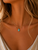 Genuine turquoise teardrop pendant necklace suspended from the Angela West Designs Paloma 14K gold-filled chain, displayed on a model.