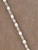 The Valencia Lariat is a striking chain necklace crafted from sterling silver links, designed to float and shimmer on the neckline and decolletage.