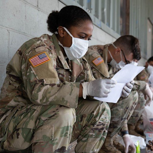 A military service member reading a letter of gratitude in support of heroism.