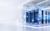 Decorative bright enterprise datacenter showroom with illuminated server racks and blue glass architecture