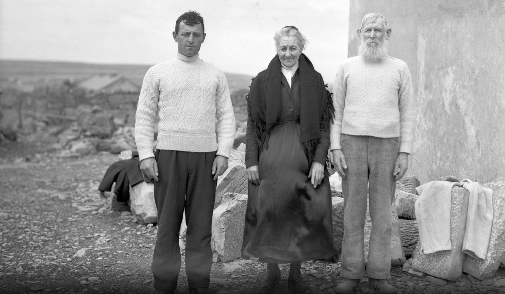 Three Aran islanders in traditional Aran sweaters and shawl