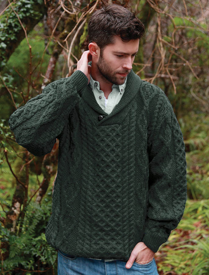 Man wearing a dark green textured wool sweater in woodland