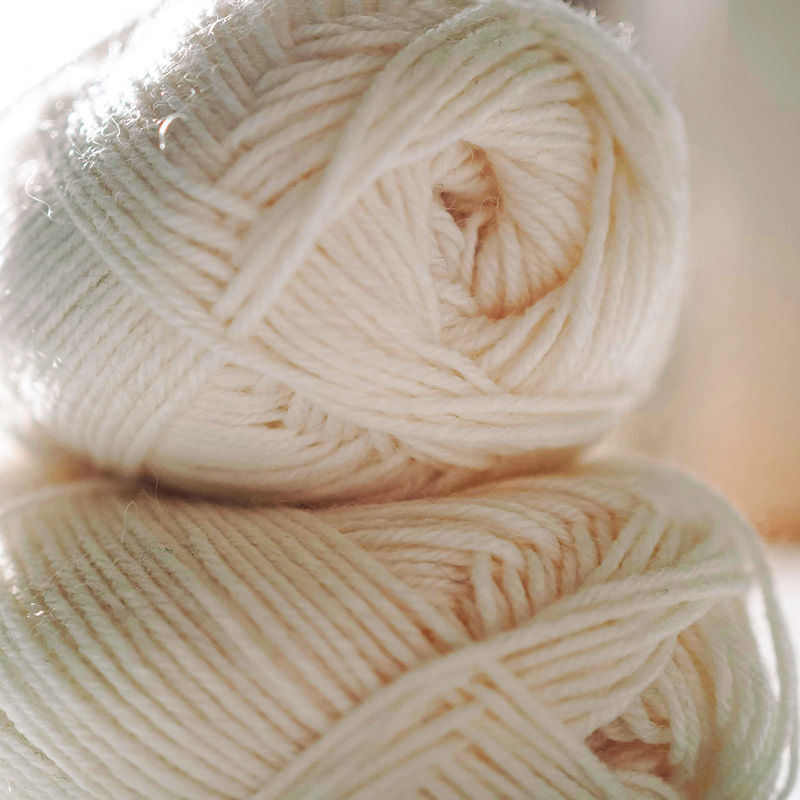 A ball of soft cream Aran wool yarn