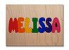 Wooden One Name Puzzle with all capital letters on a natural background.