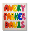 Wooden three name puzzle with all capital letters, pegs in each letter piece and a natural color background.