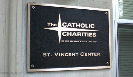 Exterior Cast Bronze Plaque with leather - pebbled background, raised logo and copy with flat, standard border.