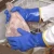Blue insulated PVC glove holding a fish
