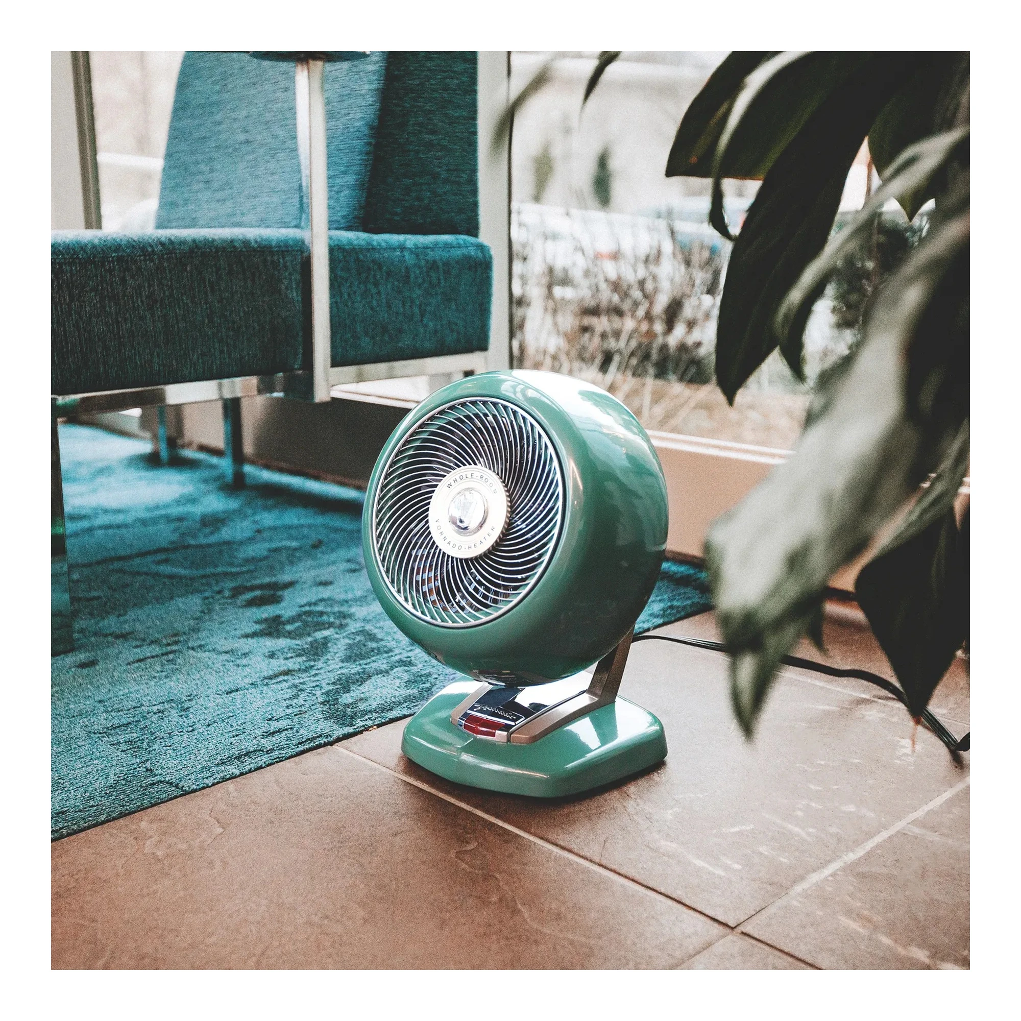 Green portable electric whole room heater with pivoting head