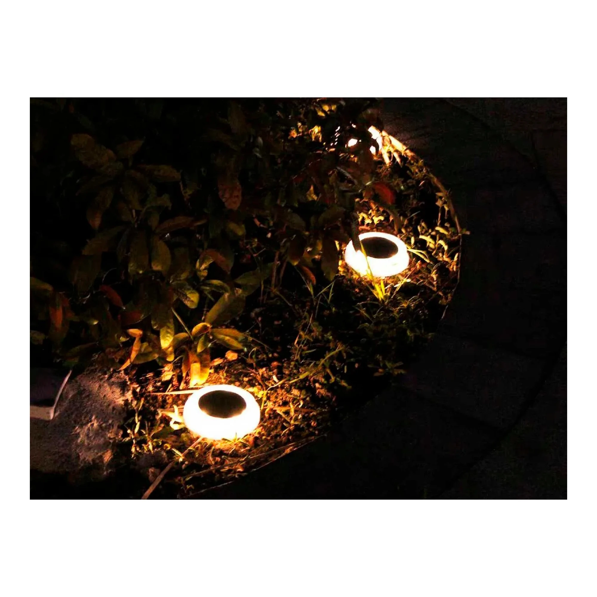 Four-pack of round solar-powered garden lights with warm white LEDs