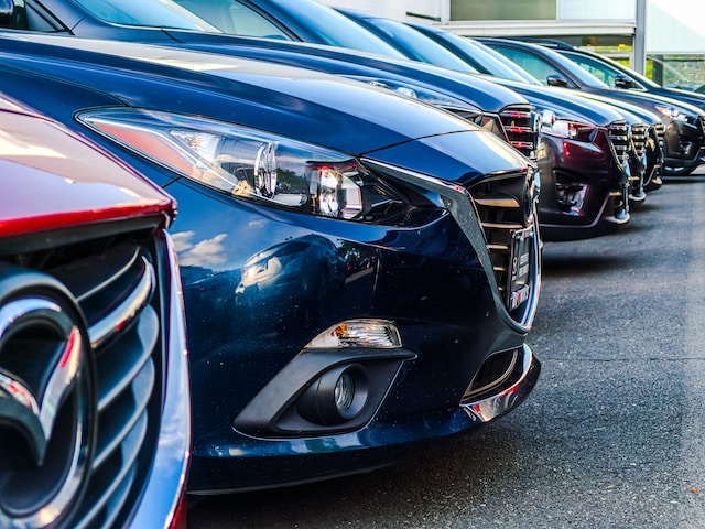 Fleet of cars parked at an automotive dealership.