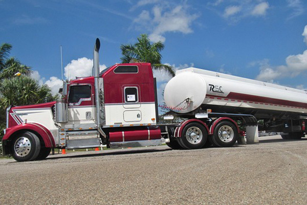 Fuel tanker truck turning on road.