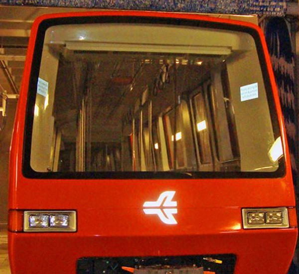 Red subway car being washed