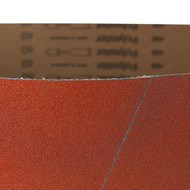 Red 25x60 inch ceramic wide sanding belt showing its abrasive surface and bi-directional butt joint.